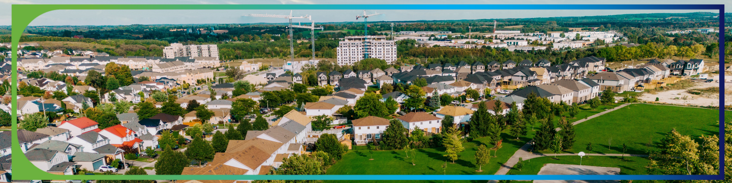 overhead image of a park area with a subdivision, condos and more new development in the background