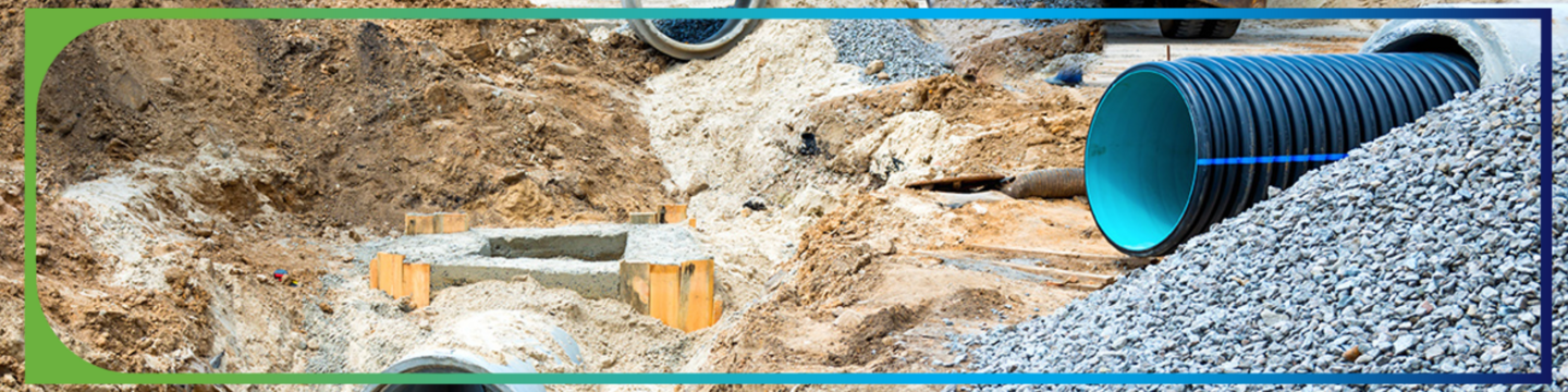 Road construction showing pipe and sewage infrastructure.